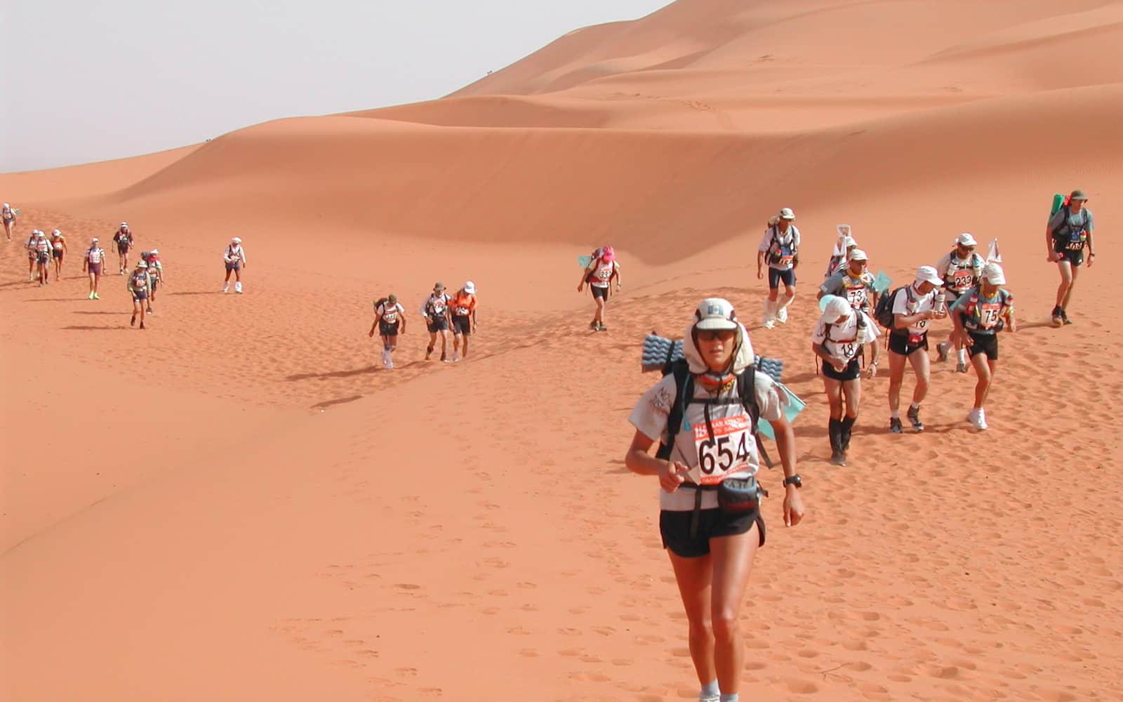 Runners crossing desert terrain at Marathon des Sables
